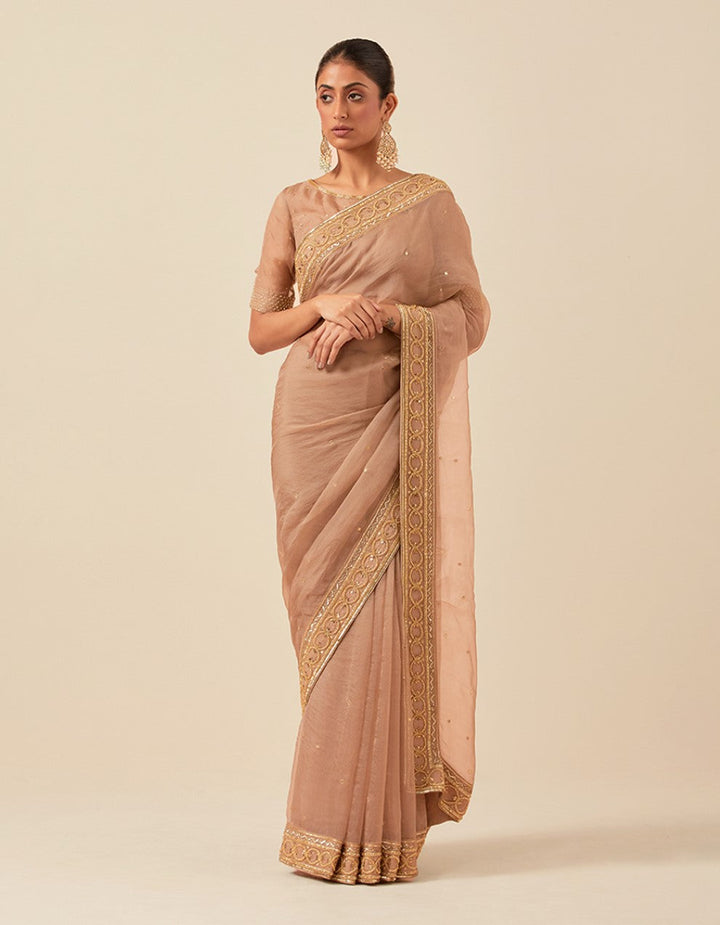 Nude organza hand work blouse and saree with satin petticoat