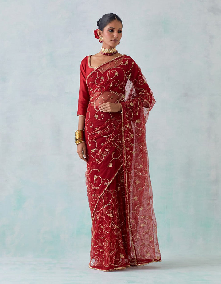 Red embroidered chanderi blouse with net saree and satin petticoat