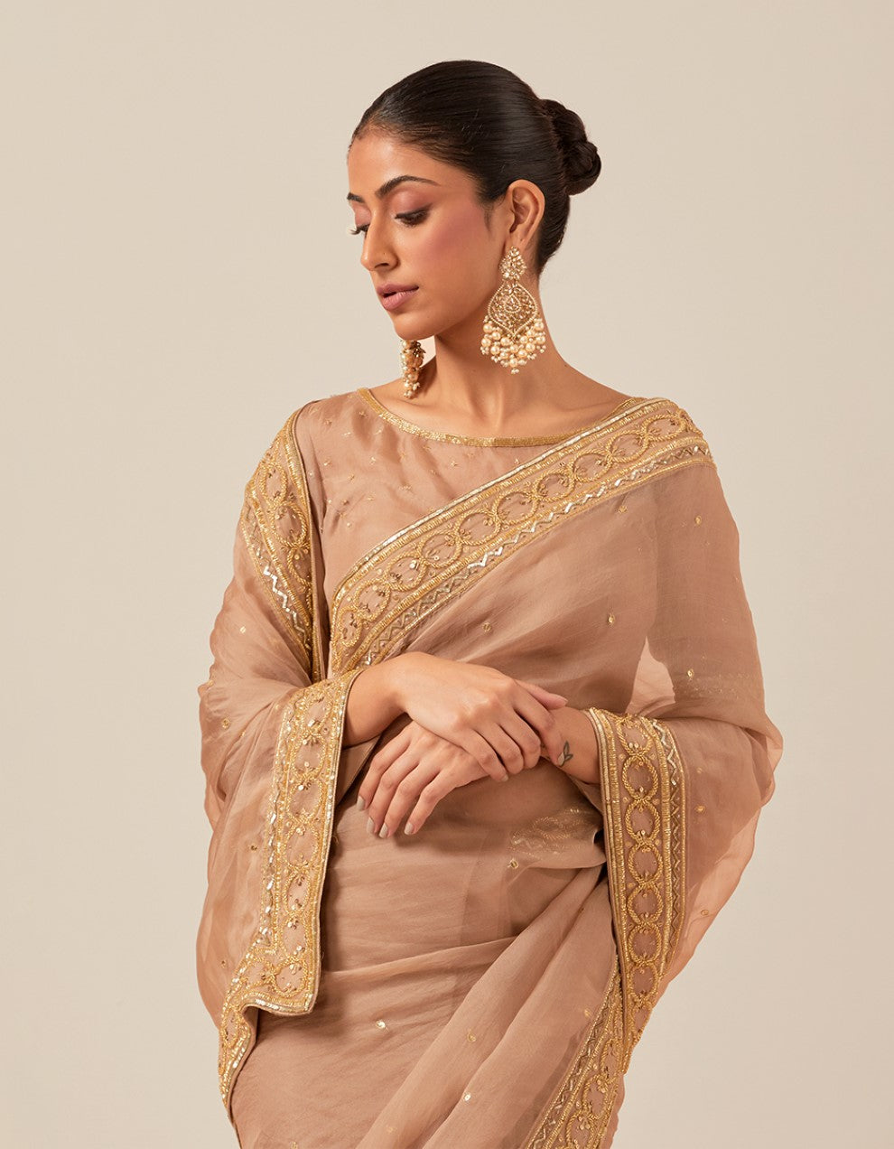 Nude organza hand work blouse and saree with satin petticoat