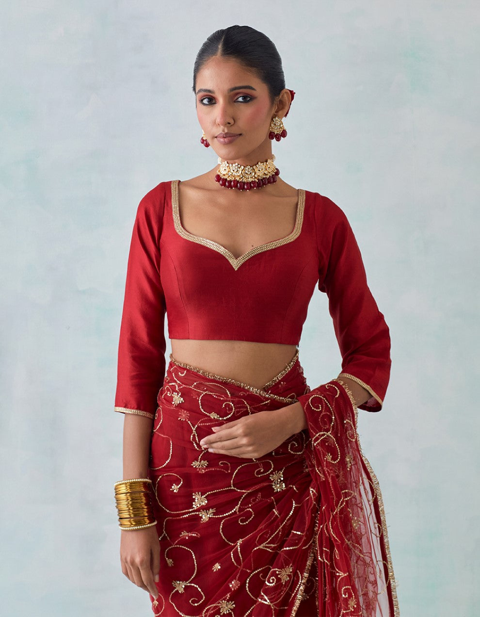 Red embroidered chanderi blouse with net saree and satin petticoat