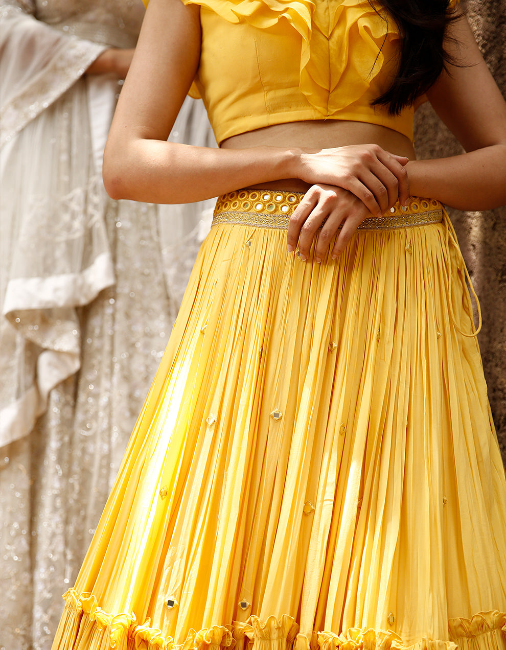 Yellow Crepe lehenga with mirror work and organza frill blouse