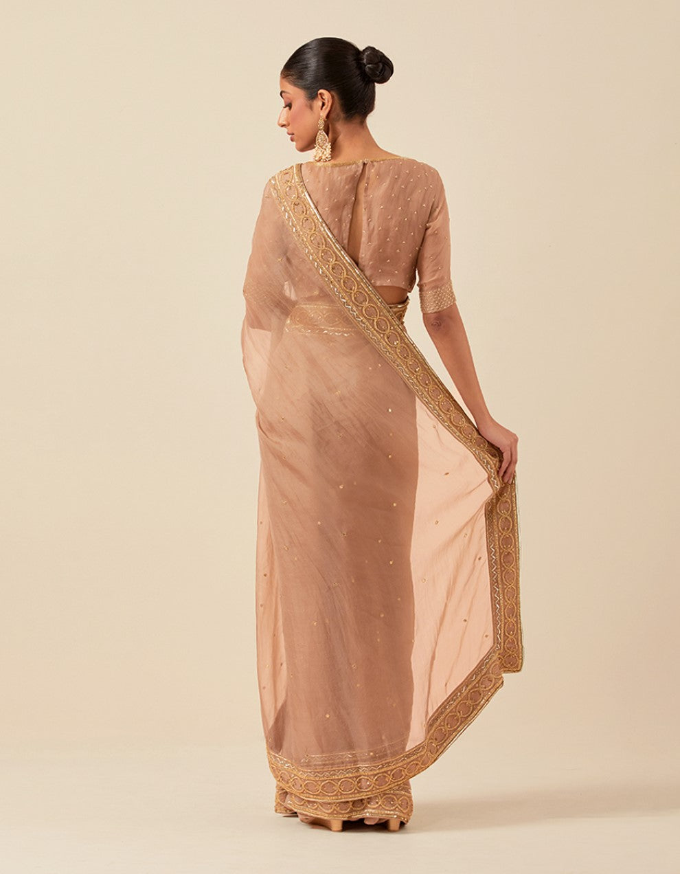 Nude organza hand work blouse and saree with satin petticoat