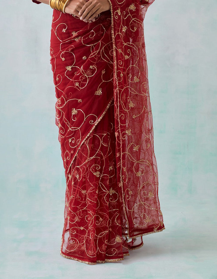 Red embroidered chanderi blouse with net saree and satin petticoat